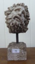 A composition ornament, a male bust, on a spike and plinth  12"h overall