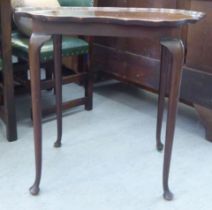 A 1920s mahogany occasional table, the top with lobed corners, raised on cabriole legs  26"h  29"w