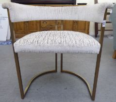 A modern A/R polished and gilded, square section, tubular steel framed, round back chair,
