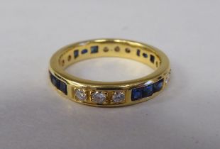 An 18ct gold sapphire and diamond set, full eternity ring