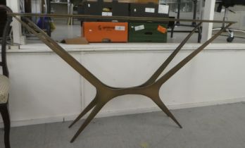 A modern gilded steel framed console table with a plate glass top  34"h  59"w
