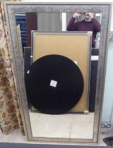 A modern mirror, set in a brushed metal effect wooden frame  70" x 40"