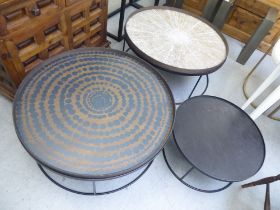 A nesting set of three Notre Monde matt black finished steel coffee tables with painted wooden