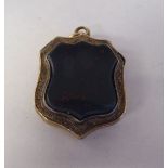 An antique engraved yellow metal, hinged locket, set with a bloodstone