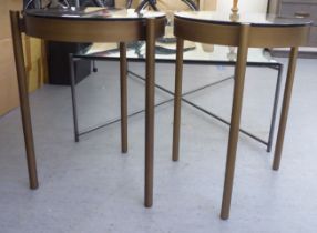 A pair of modern gilded steel framed side tables with smoked plate glass tops  23"h  16"dia