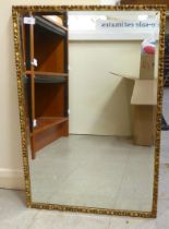 A modern mirror, the bevelled plate set in a gilded frame  31" x 21"