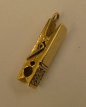 A Tiffany & Co (probably 18ct gold) charm, fashioned as a peg, set with four small diamonds