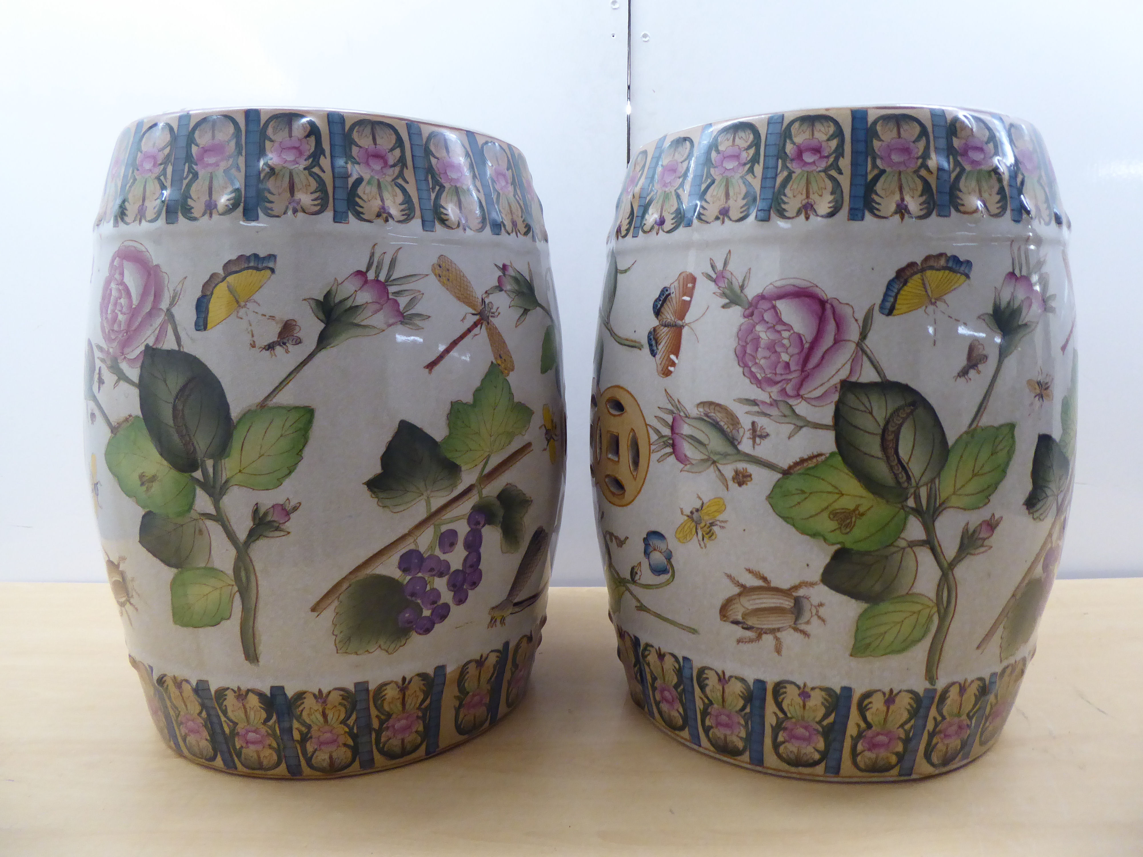 A pair of 19thC Chinese style ceramic barrel stools, decorated in colours with mixed flora, - Bild 2 aus 5