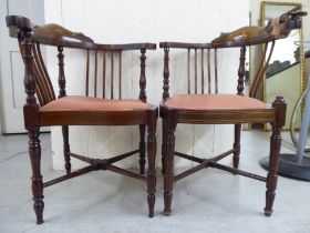 A pair of Edwardian satinwood inlaid mahogany framed corner salon chairs, raised on turned legs