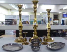 Mixed metalware: to include three graduated bronze candlesticks  tallest 20.5"h