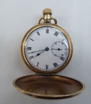 An early 20thC gold plated Hunter pocket watch, faced by an enamelled Roman dial