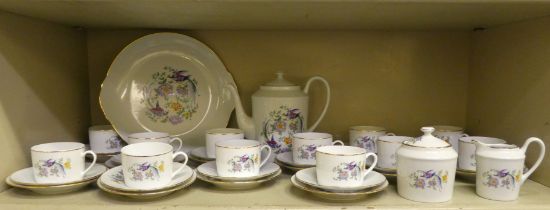 A Limoges porcelain tea set, decorated in gilt trim, birds and floral decoration