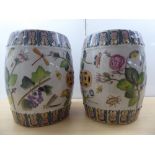 A pair of 19thC Chinese style ceramic barrel stools, decorated in colours with mixed flora,