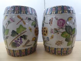 A pair of 19thC Chinese style ceramic barrel stools, decorated in colours with mixed flora,