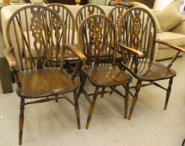 A set of six early/mid 20thC stained beech framed, hoop, wheel and spindle back Windsor chairs,