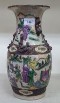 An early 20thC Japanese crackle glazed porcelain vase, decorated with figures in battle, in a