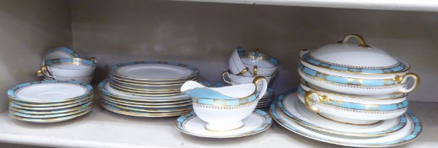 An Aynsley china dinner service, decorated with turquoise and gilt bands