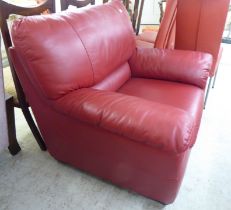 A modern red faux hide upholstered armchair