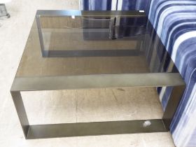 A modern burnished bronze coloured, steel framed coffee table with smoked plate glass top  17"h