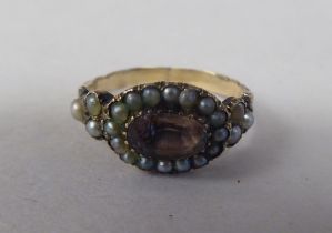 An antique yellow metal ring, set with a seed pearls