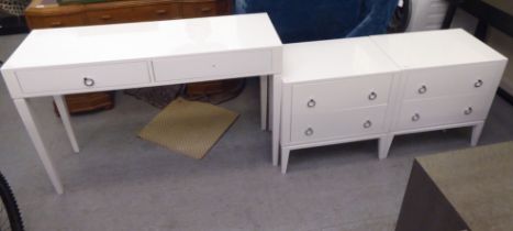 A pair of modern ivory coloured, laminated, two drawer bedside cupboards with ring handles, raised