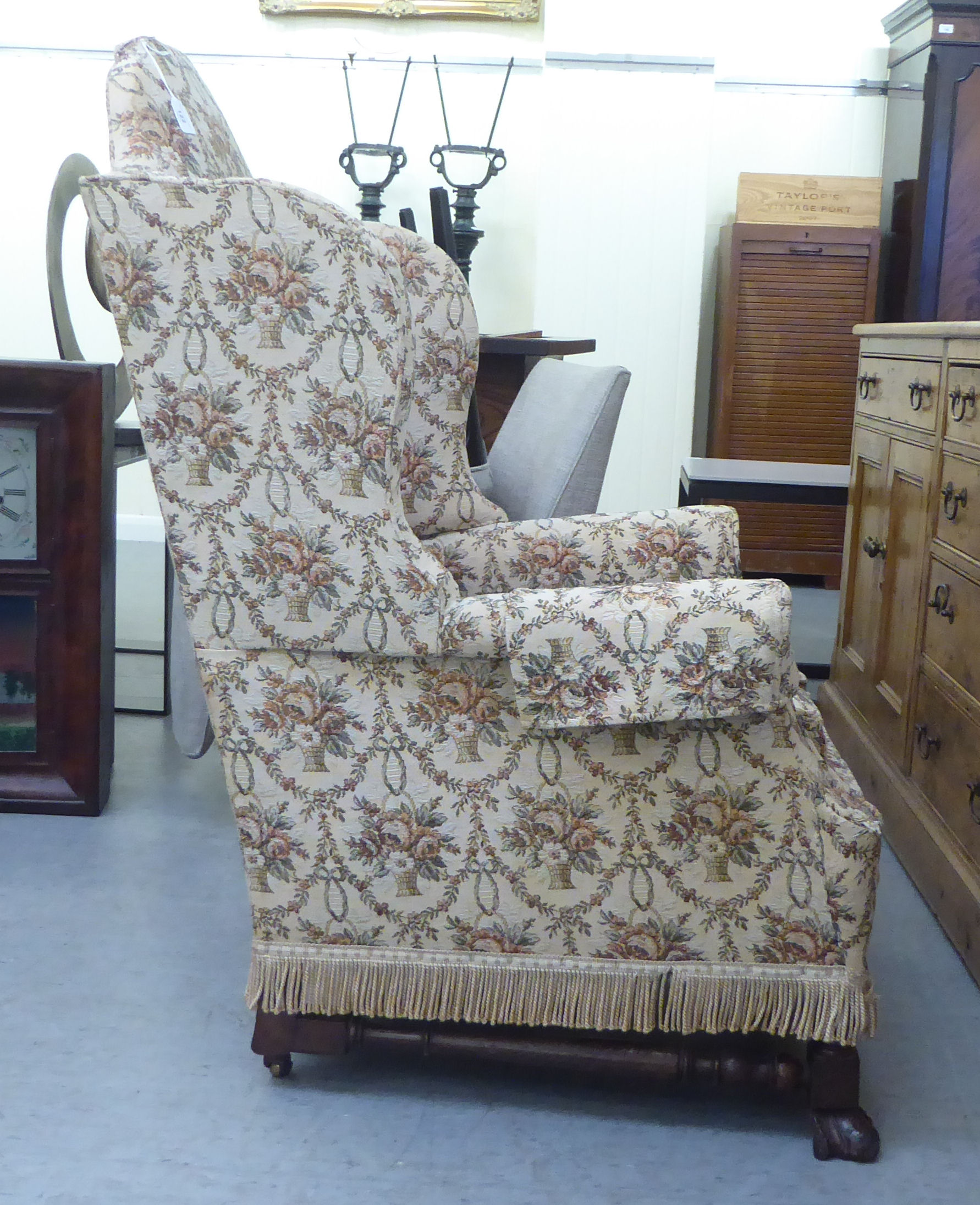 A late 19thC walnut framed tapestry upholstered wingback armchair, raised on paw feet - Bild 4 aus 4