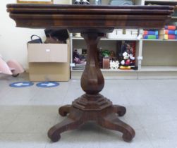 A mid 19thC rosewood veneered card table, raised on a quatrefoil base  31"h  34"w