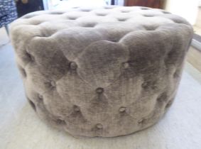 A modern buttoned grey fabric upholstered stool  29"dia