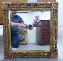 A modern mirror, the plate set in a moulded gilt frame  21"sq