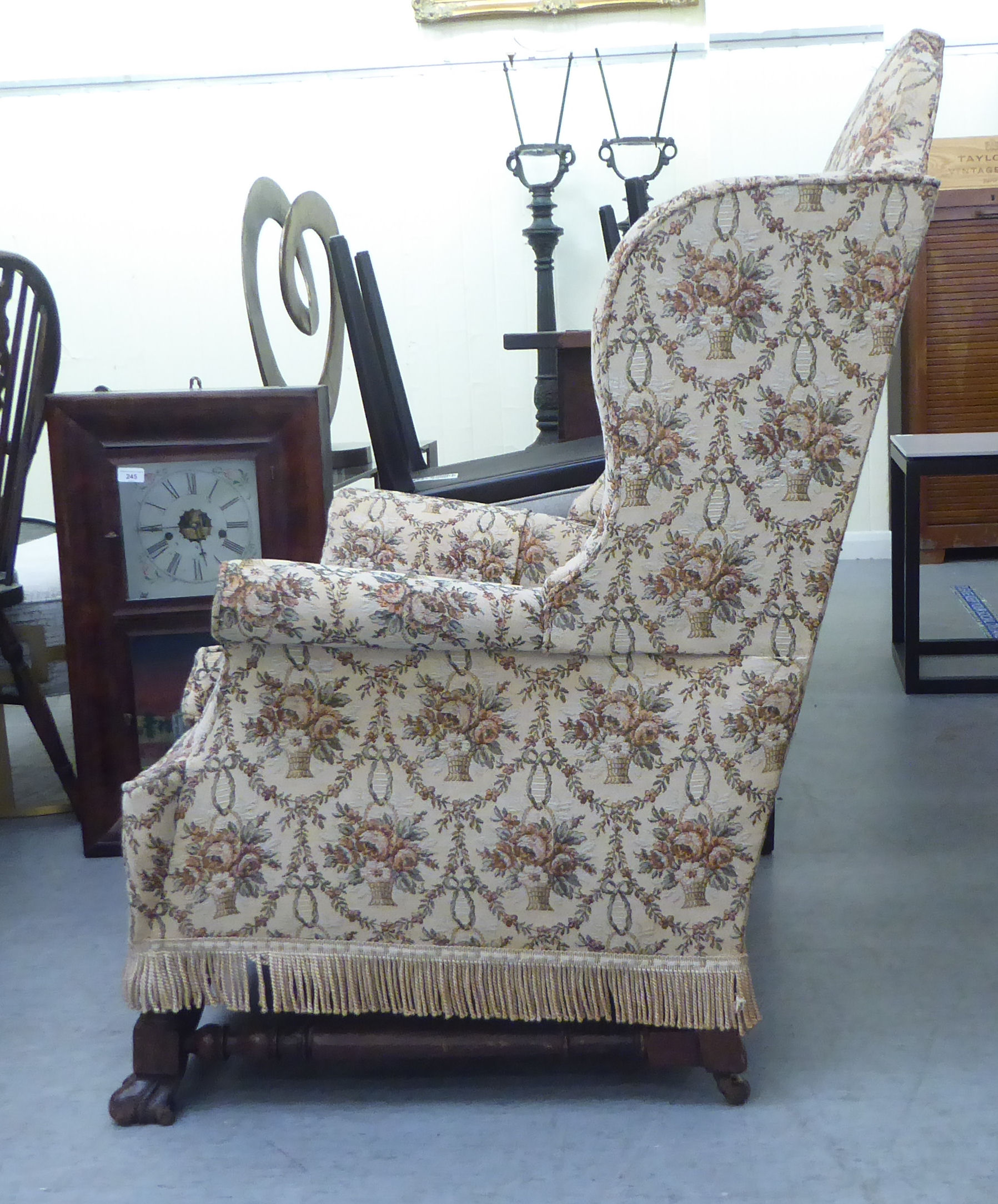 A late 19thC walnut framed tapestry upholstered wingback armchair, raised on paw feet - Bild 2 aus 4