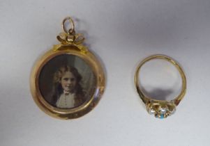 A 9ct gold ring set with turquoise and seed pearls; and a 9ct gold double sided, pictorial locket