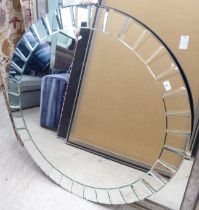 A modern mirror, set within a border of radiating bevelled mirrored panels  44"dia