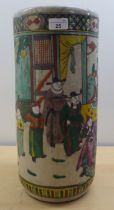 A 19thC Oriental style cylindrical ceramic stickstand, decorated in colours with conversational