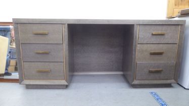 A modern mottled grey laminate dressing table with six drawers, on a plinth  31"h  68"w
