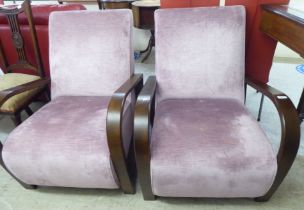 A pair of modern Art Deco design stained beech framed armchairs, each upholstered in purple