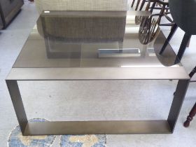 A modern burnished bronze coloured, steel framed coffee table with smoked glass top  17"h  36"sq