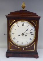 A George III mahogany cased bracket clock with a stepped top, gilt metal pineapple finial and