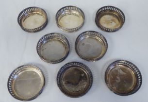 A set of eight silver coloured metal coasters with decoratively pierced galleried sides  stamped 800