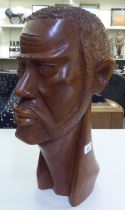 An African carved fruitwood bust of a man  19"h