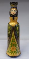 A Russian turned and painted softwood bottle vase, featuring a young woman wearing traditional