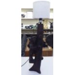 A mid 20thC carved Black Forest table lamp, fashioned as a bear climbing a tree  24"h