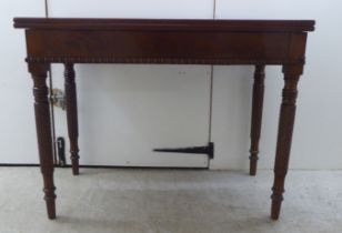 An early 19thC mahogany tea table with a foldover top, raised on turned ropetwist legs  31"h  40"w