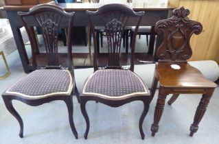 Two Edwardian mahogany framed salon chairs with splat backs, raised on cabriole legs; and a mid
