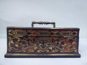 A late 19thC desktop boulleworked tortoiseshell stand with straight sides and two outward hinged