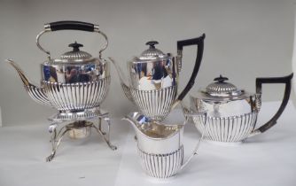 A late Victorian four piece silver tea set of oval, demi-reeded form  comprising a teapot and