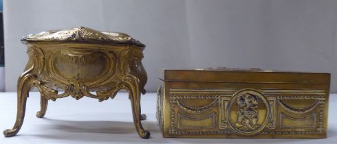A late 19thC cast gilded metal jewellery box, fashioned as a commode, the hinged lid enclosing a
