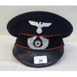 A German military peaked cap with badge (Please Note: this lot is subject to the statement made in