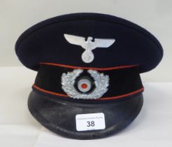 A German military peaked cap with badge (Please Note: this lot is subject to the statement made in