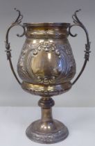 A late 19thC silver Bulawayo Rifle Club trophy cup of pedestal form with twin handles, cast and