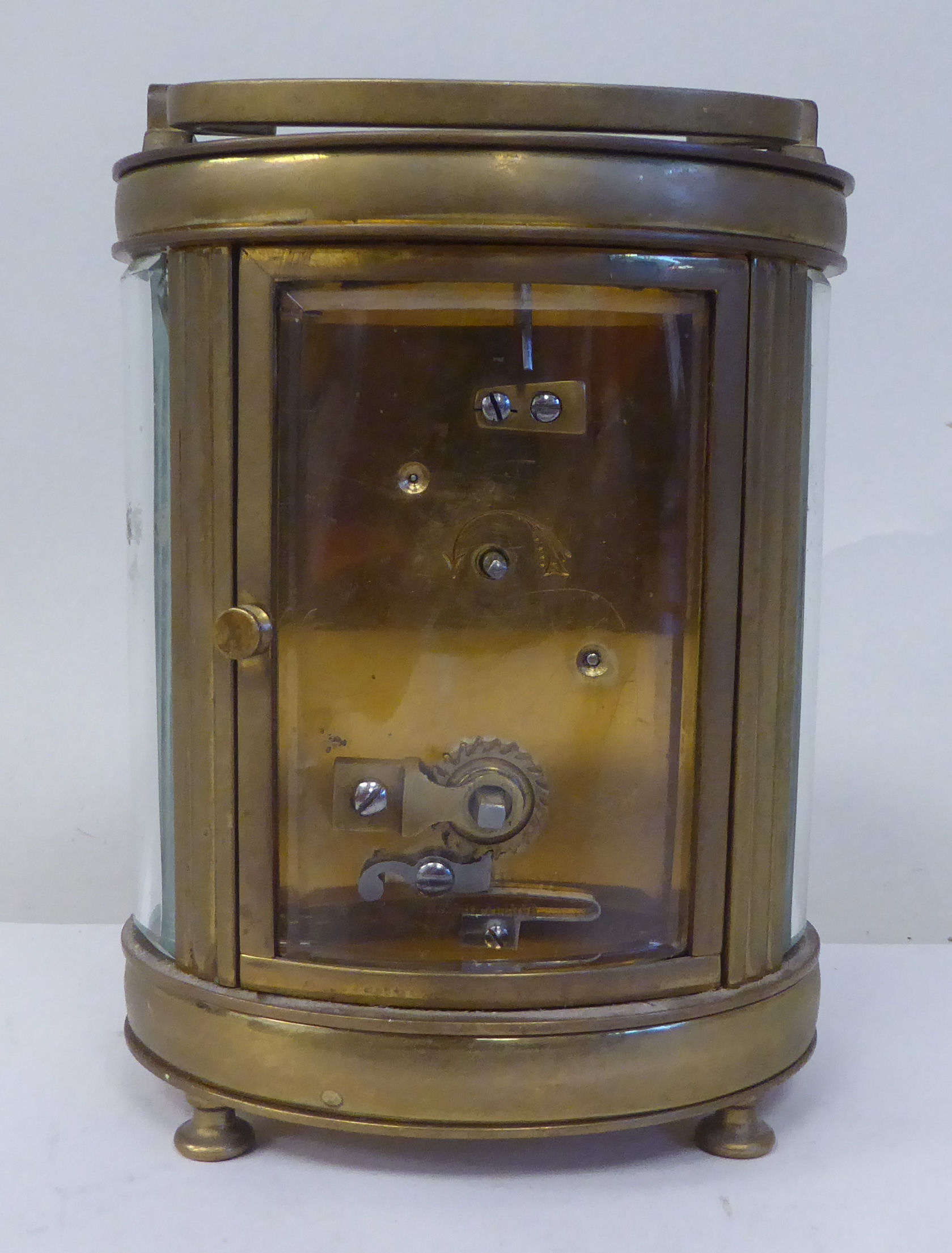 An early 20thC French oval brass cased carriage timepiece with bevelled glass panels and a folding - Image 5 of 11